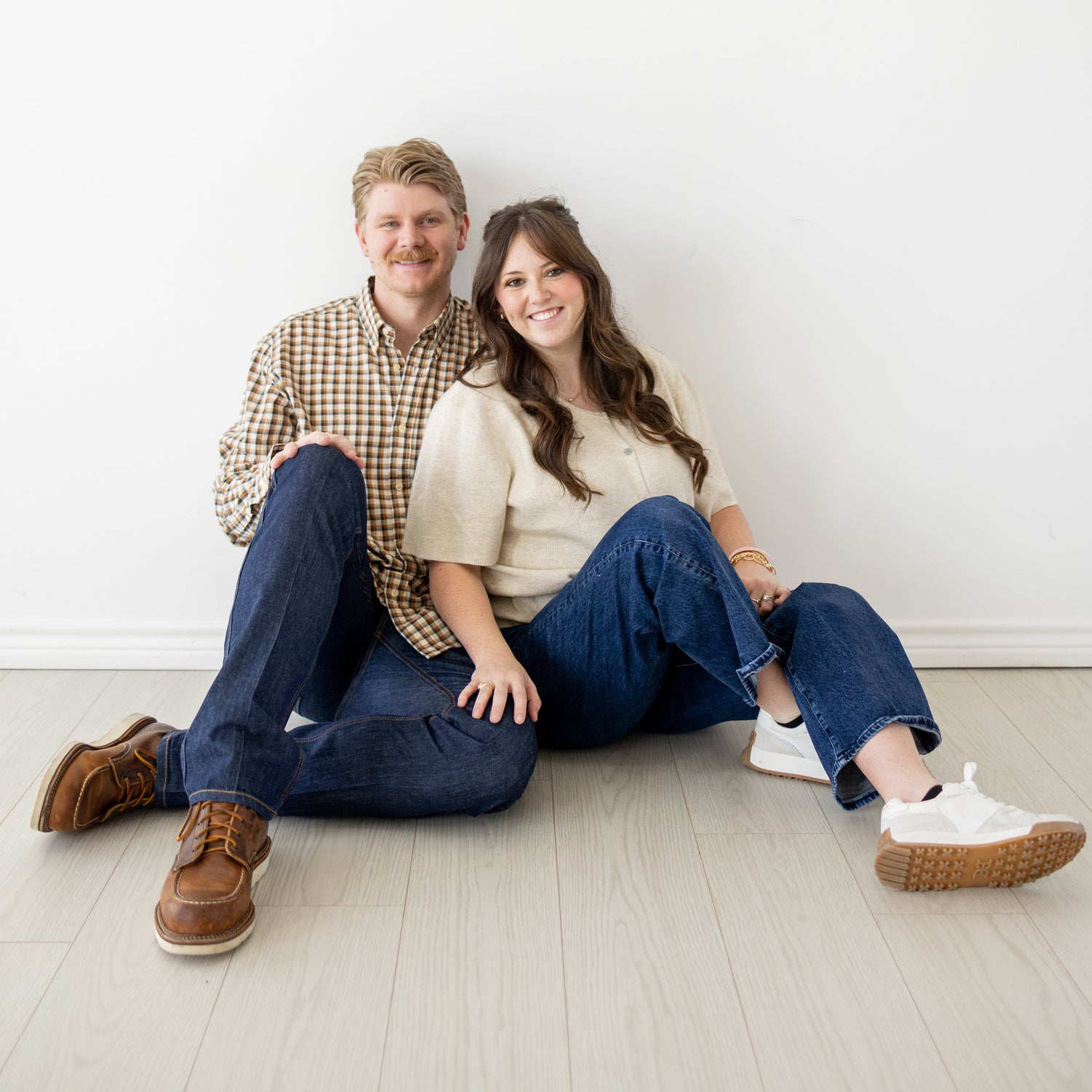 Tyler and his wife, owners of Parker County Apparel Co., standing together proudly, representing their Texas-based clothing brand inspired by local heritage and hometown pride.